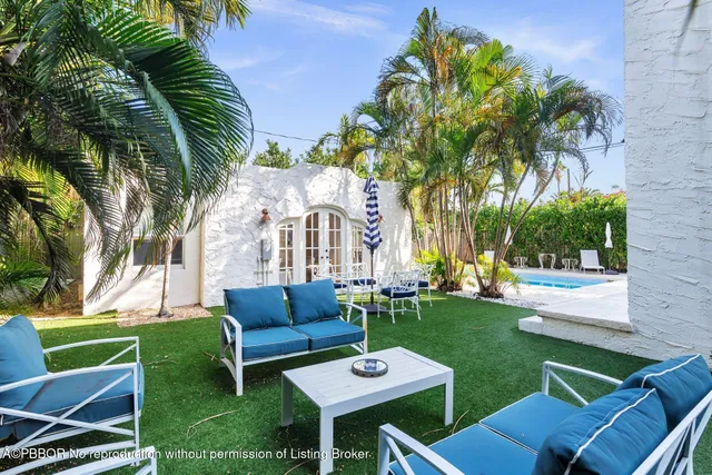 a view of a chairs and table in patio with a yard