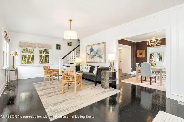 a living room with furniture wooden floor and a chandelier