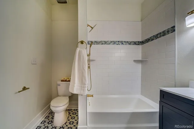 a bathroom with a bath tub with a shower