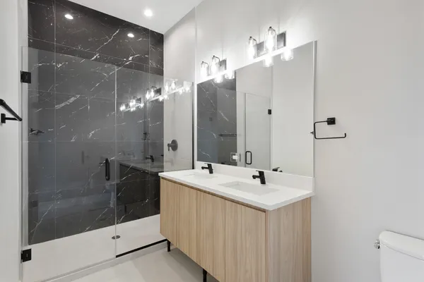a kitchen with stainless steel appliances granite countertop a refrigerator a sink and a stove