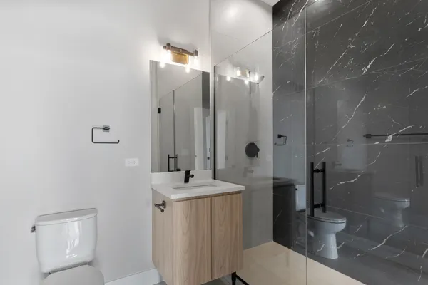a kitchen with stainless steel appliances granite countertop a sink a oven and a large window with wooden floor