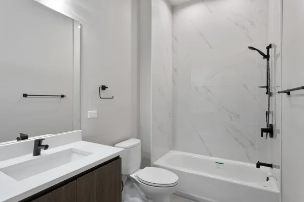 a bathroom with a sink toilet and shower