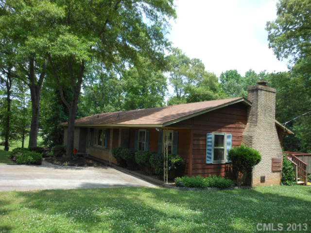 1520 Legion Road Fort Mill, SC 29715 - Photo 14 of 16 a view of a house with a yard plants and large tree