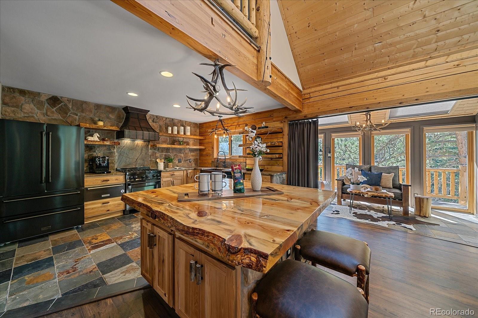 1385 Beaver Brook Canyon Road Evergreen, CO 80439 - Photo 12 of 49 a view of a kitchen with stainless steel appliances granite countertop a sink and wooden floor