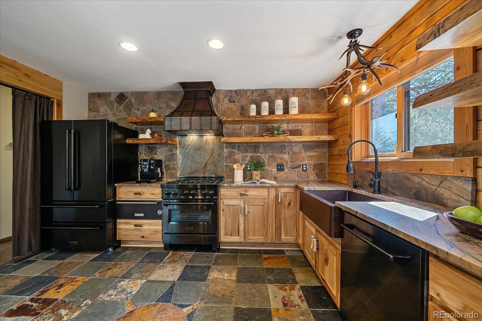 1385 Beaver Brook Canyon Road Evergreen, CO 80439 - Photo 15 of 49 a kitchen with refrigerator and cabinets