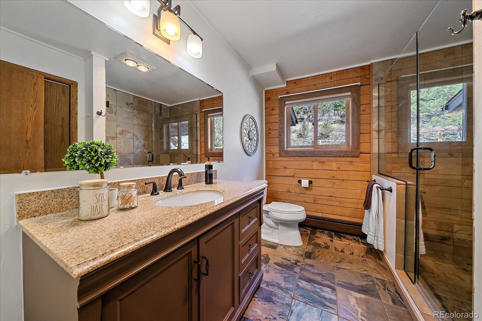 1385 Beaver Brook Canyon Road Evergreen, CO 80439 - Photo 20 of 49 a bathroom with a granite countertop sink and a mirror