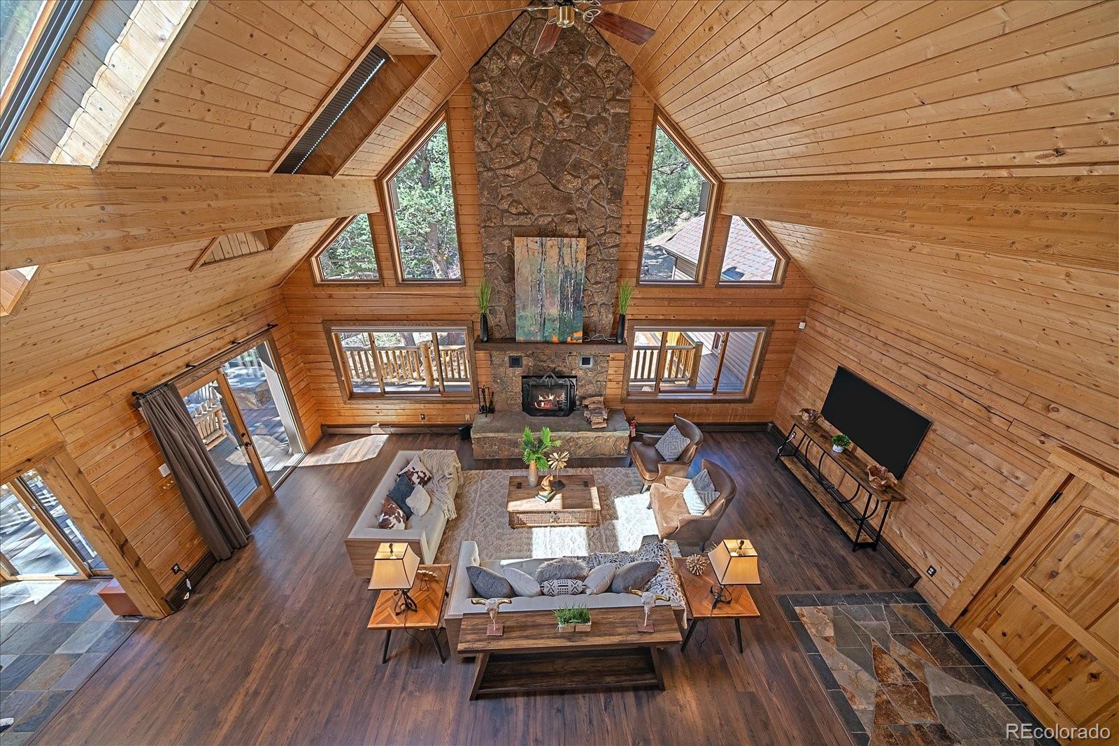 1385 Beaver Brook Canyon Road Evergreen, CO 80439 - Photo 22 of 49 a view of a house with wooden floor