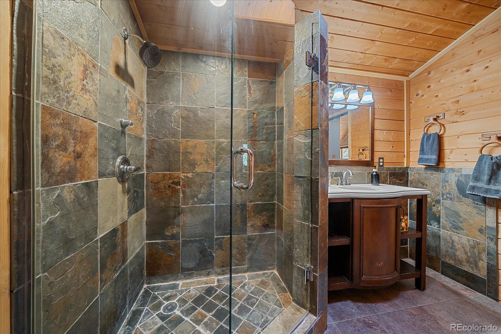 1385 Beaver Brook Canyon Road Evergreen, CO 80439 - Photo 28 of 49 a bathroom with a shower and a sink