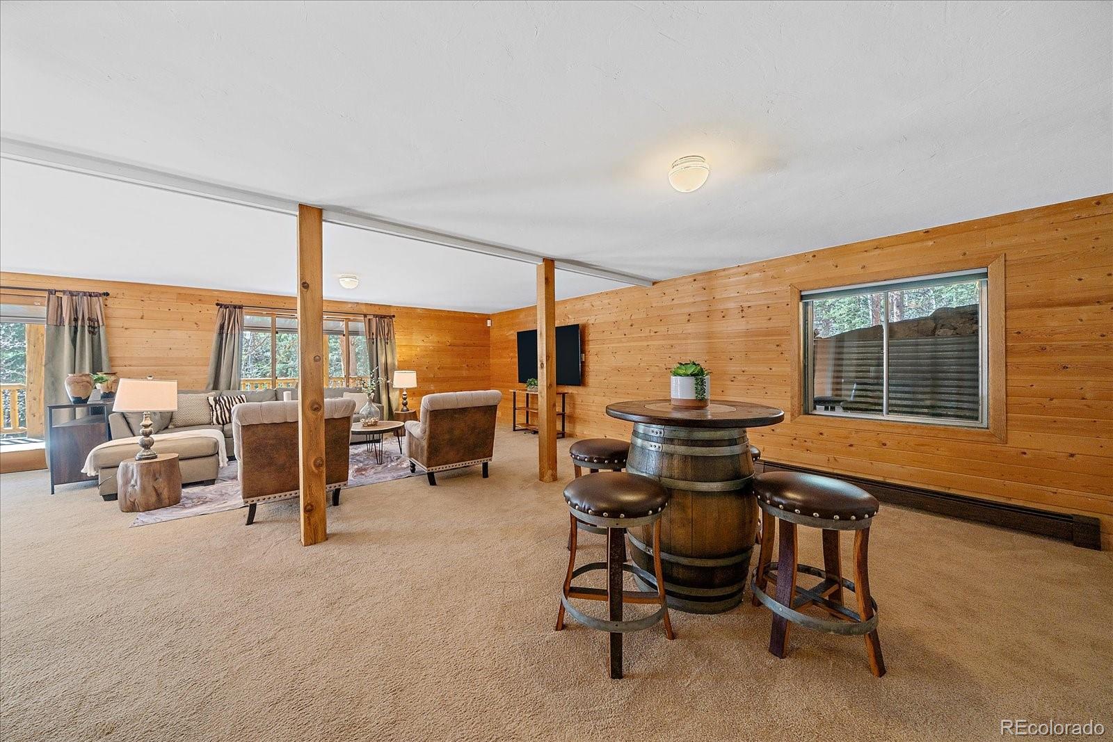 1385 Beaver Brook Canyon Road Evergreen, CO 80439 - Photo 30 of 49 a view of a work space with furniture and floor to ceiling window
