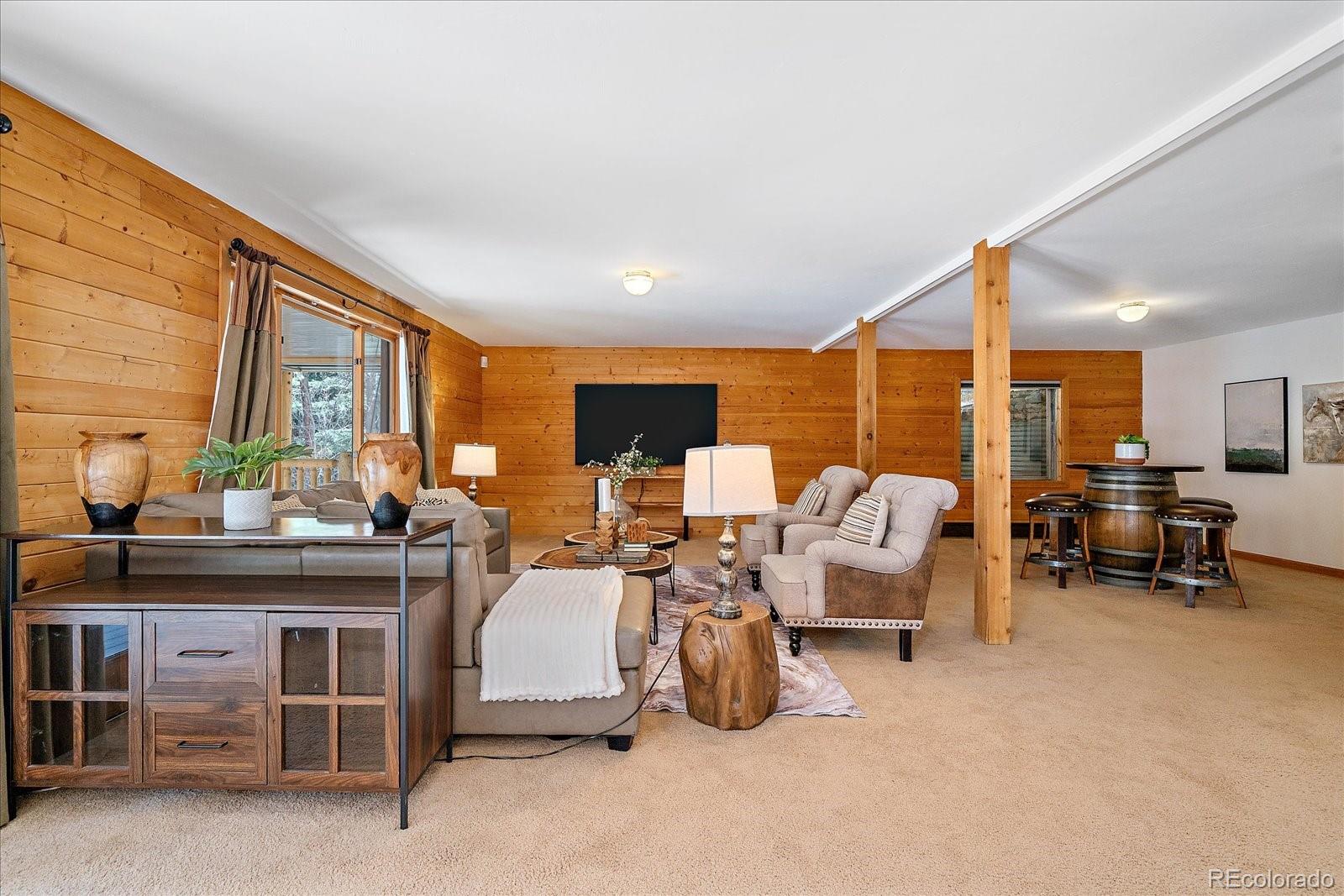 1385 Beaver Brook Canyon Road Evergreen, CO 80439 - Photo 32 of 49 a living room with furniture and a large window
