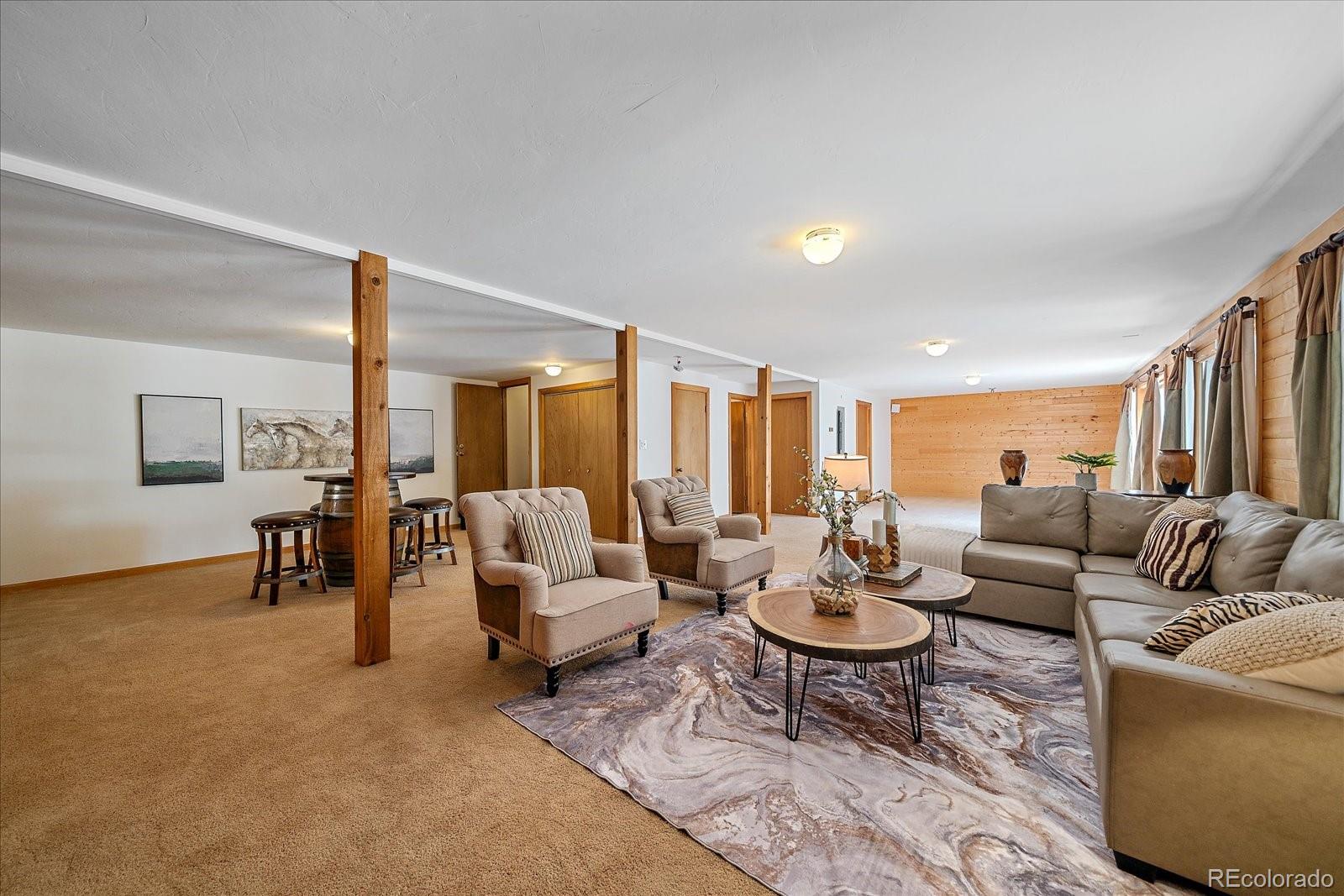 1385 Beaver Brook Canyon Road Evergreen, CO 80439 - Photo 33 of 49 a living room with furniture and a large window