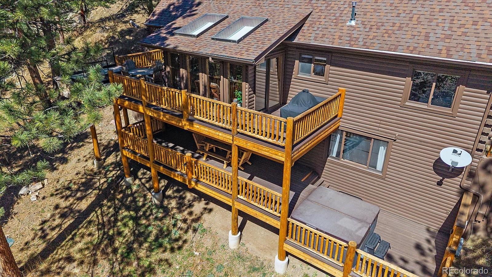 1385 Beaver Brook Canyon Road Evergreen, CO 80439 - Photo 37 of 49 an aerial view of a house with a street