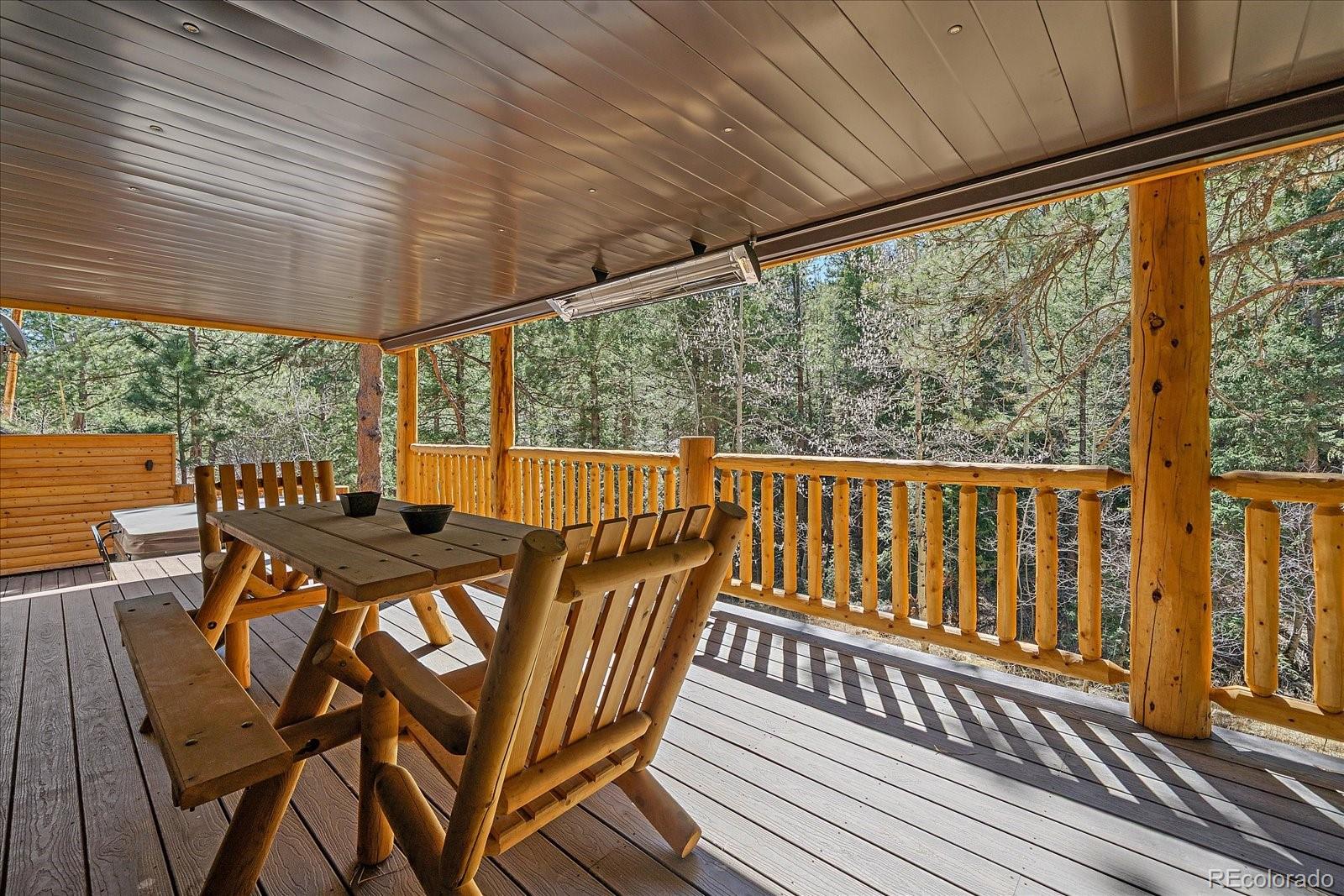 1385 Beaver Brook Canyon Road Evergreen, CO 80439 - Photo 39 of 49 a view of a chairs and table in the balcony