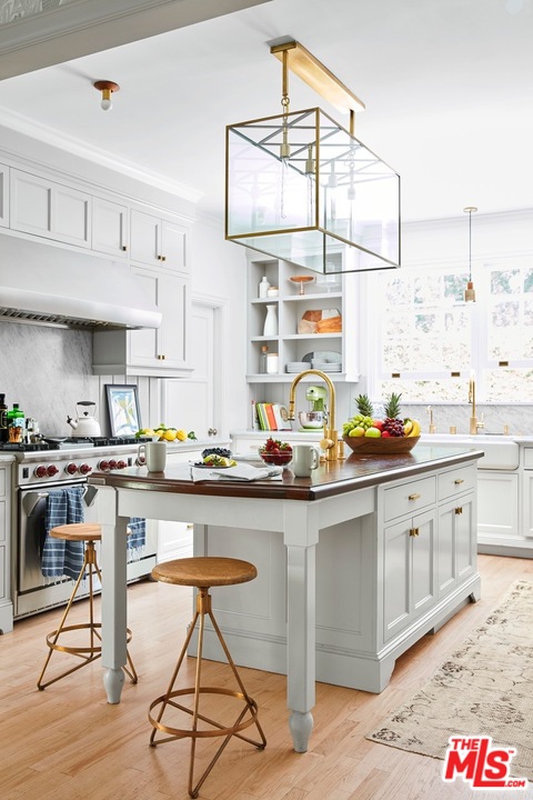 555 South Rimpau Boulevard Los Angeles, CA 90020 - Photo 5 of 17 a kitchen with stainless steel appliances granite countertop a sink and cabinets
