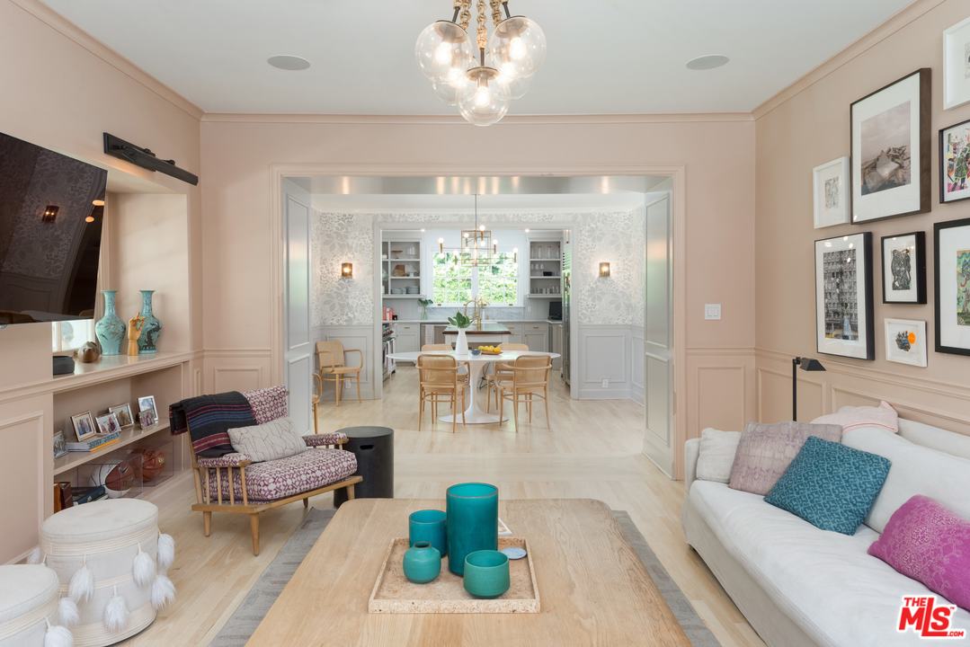 555 South Rimpau Boulevard Los Angeles, CA 90020 - Photo 7 of 17 a living room with furniture a chandelier and a flat screen tv