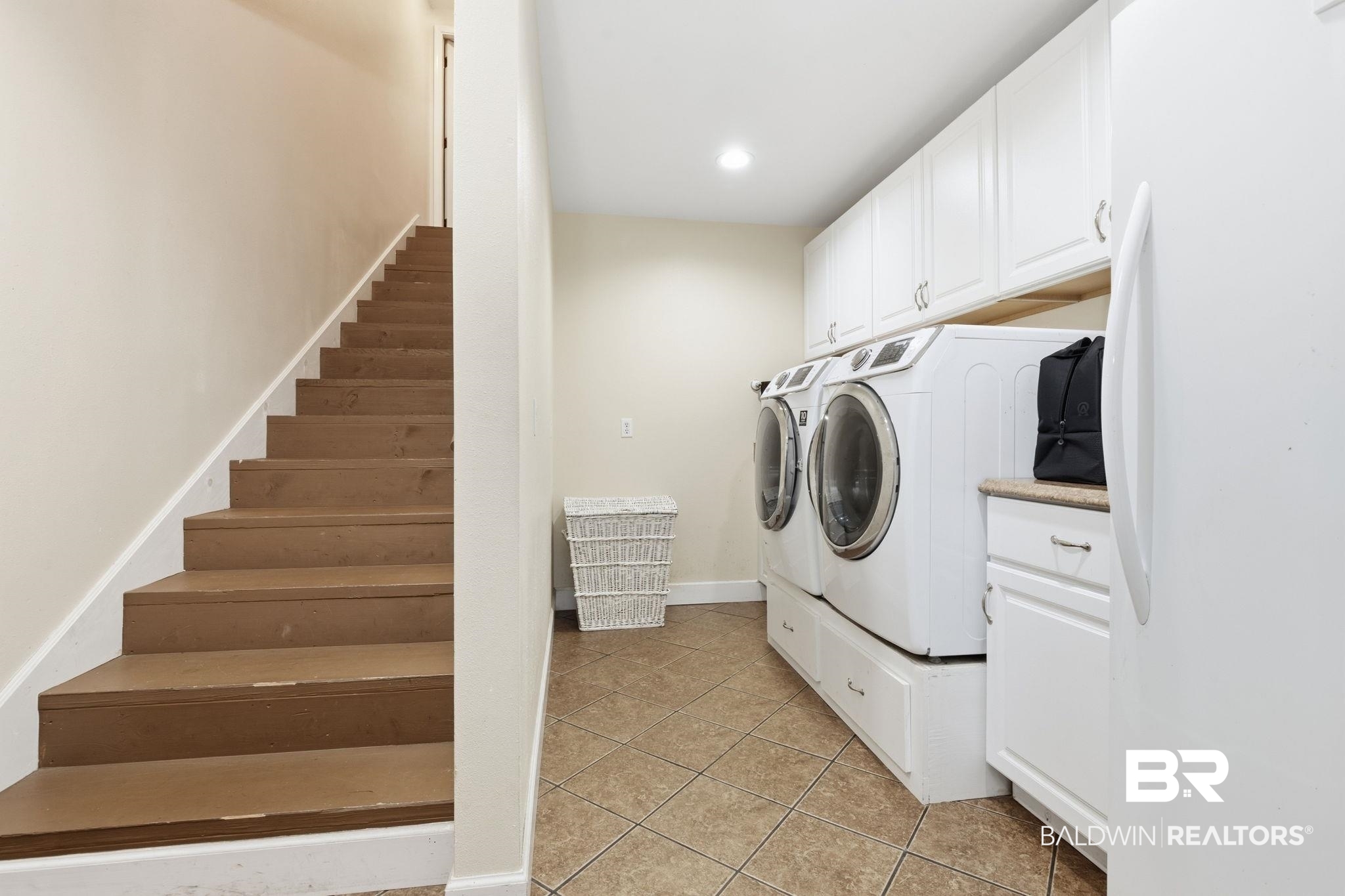 15025 Bellingrath Road Coden, AL 36523 - Photo 61 of 79 Laundry area with light tile patterned flooring, washer and dryer, cabinet space, and recessed lighting