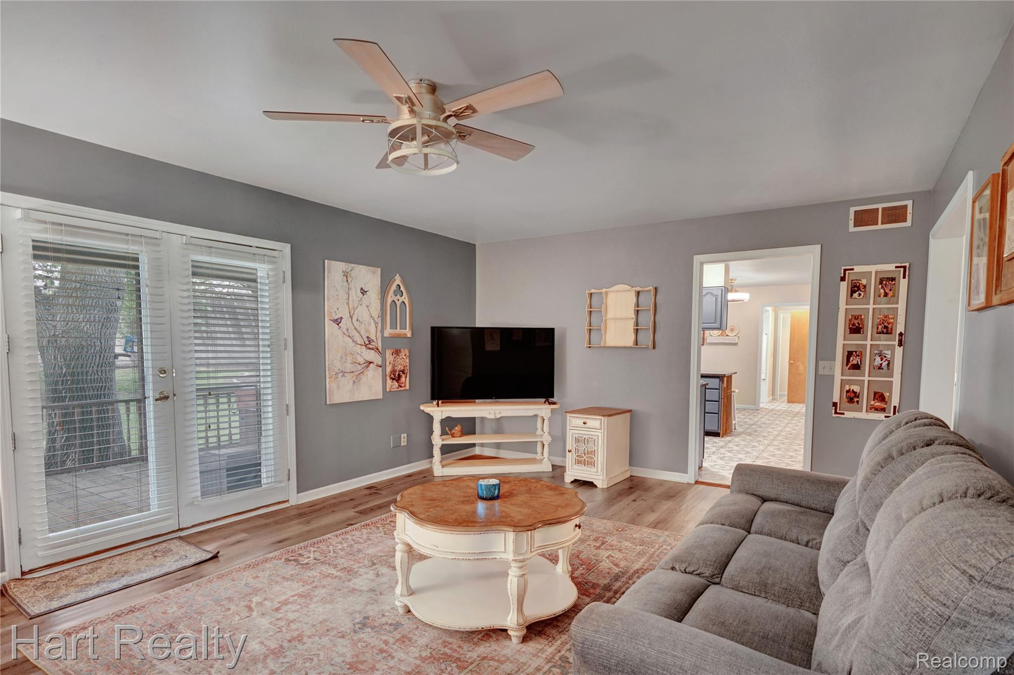7167 Brown School Road North Branch, MI 48461 - Photo 15 of 51 Inviting living area featuring wood-finish flooring, a ceiling fan with integrated lighting, and neutral wall tones