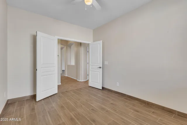 a view of an empty room and wooden floor