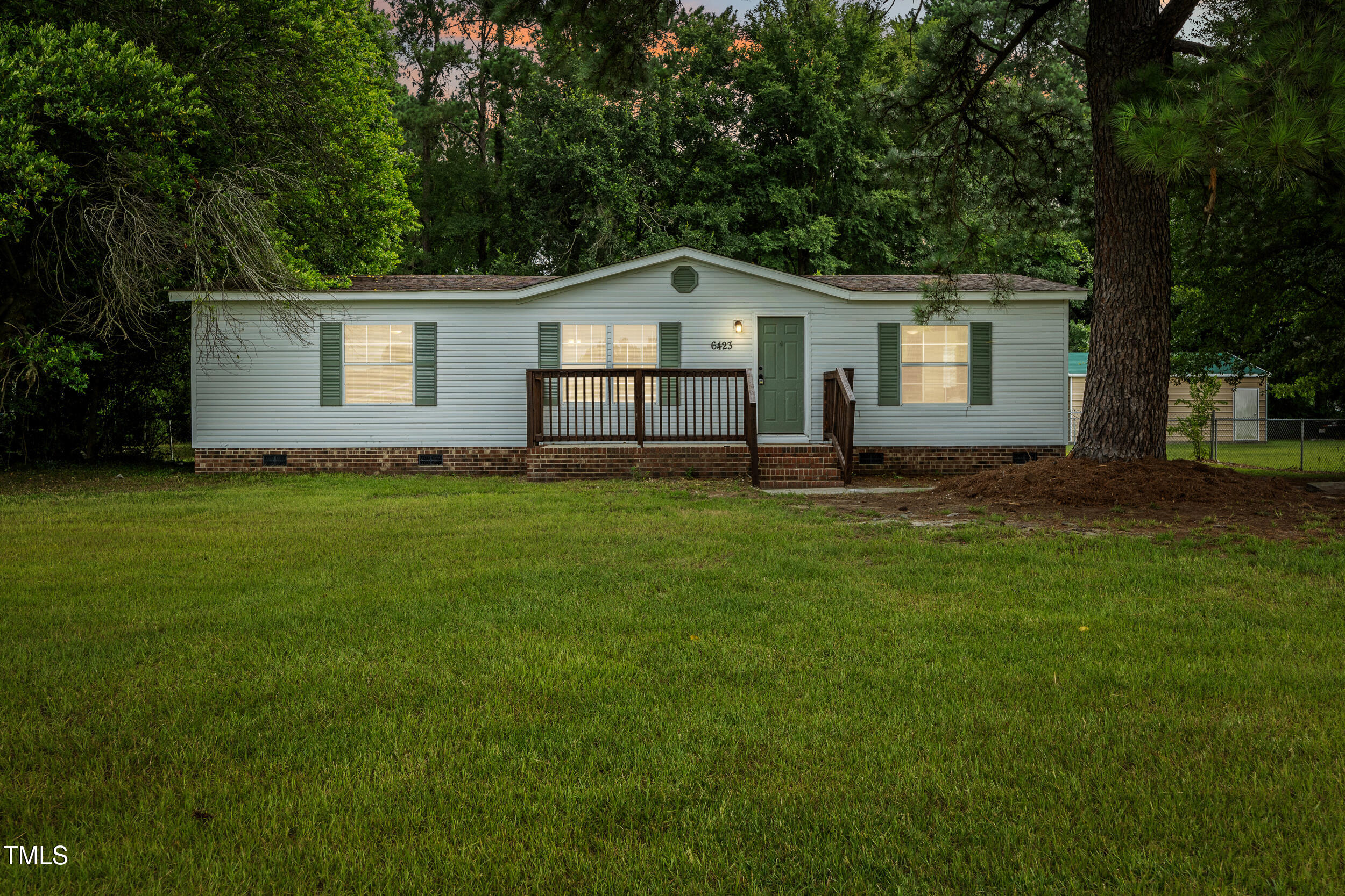 a front view of house with yard and green space