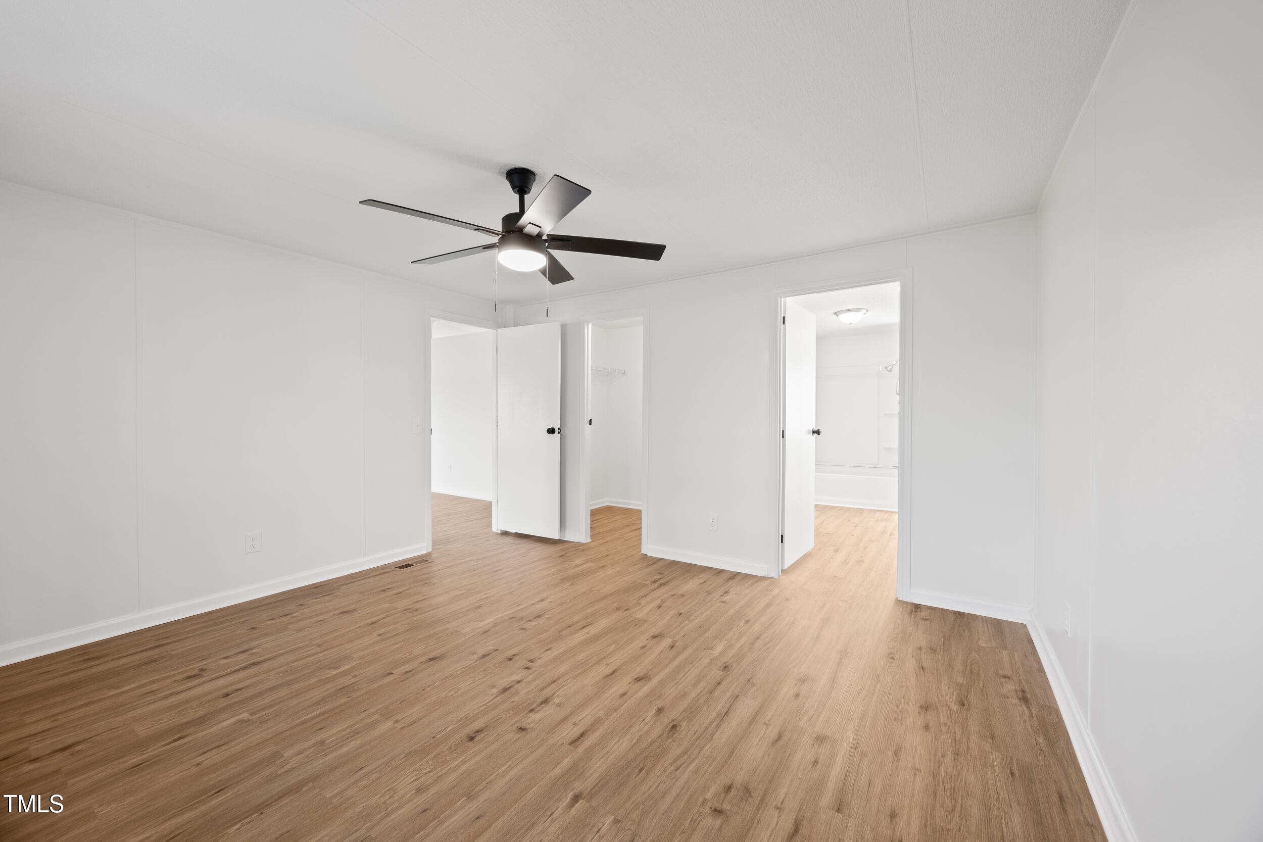 6423 Sandy Creek Road Stedman, NC 28391 - Photo 15 of 40 a view of an empty room with wooden floor