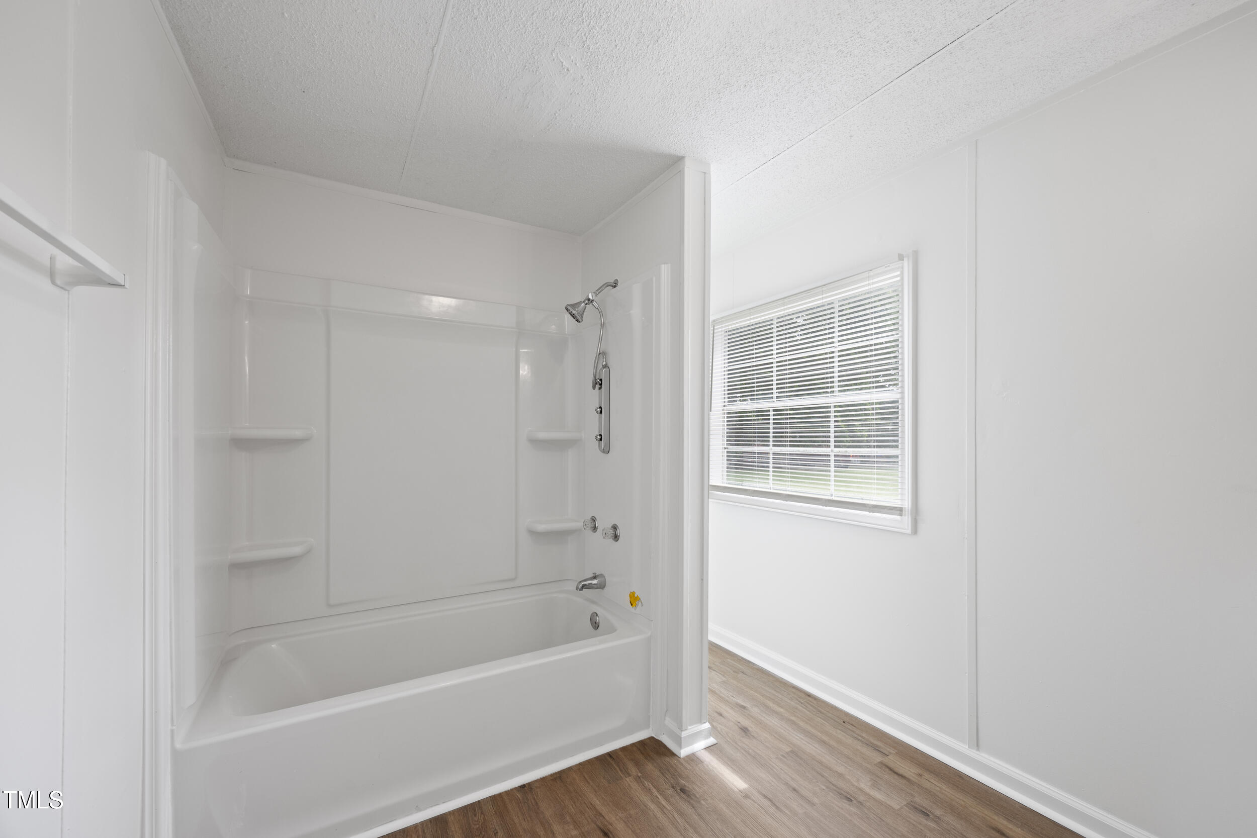 6423 Sandy Creek Road Stedman, NC 28391 - Photo 19 of 40 a white bath tub sitting next to a window