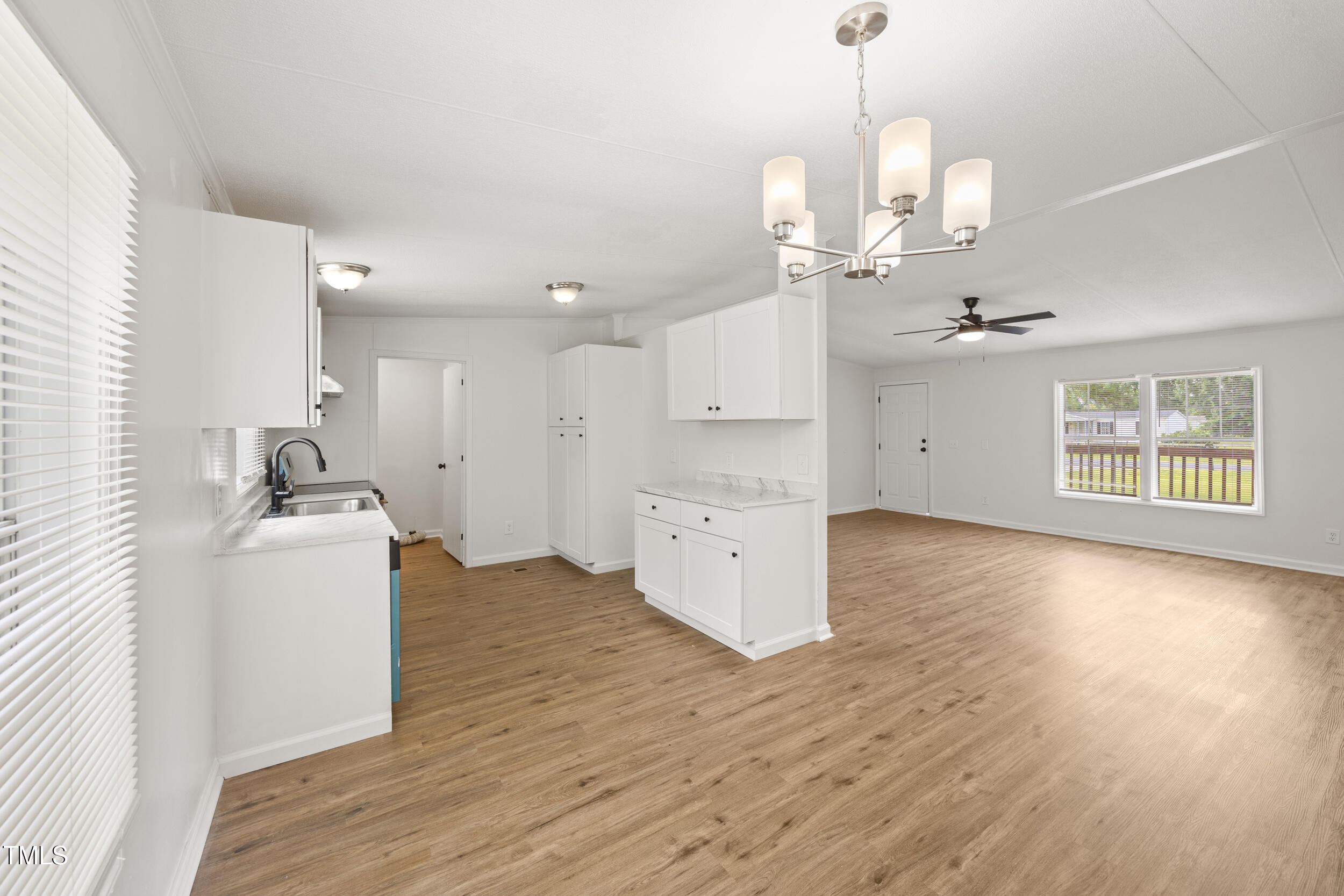 6423 Sandy Creek Road Stedman, NC 28391 - Photo 21 of 40 a view of a kitchen with a sink and wooden floor