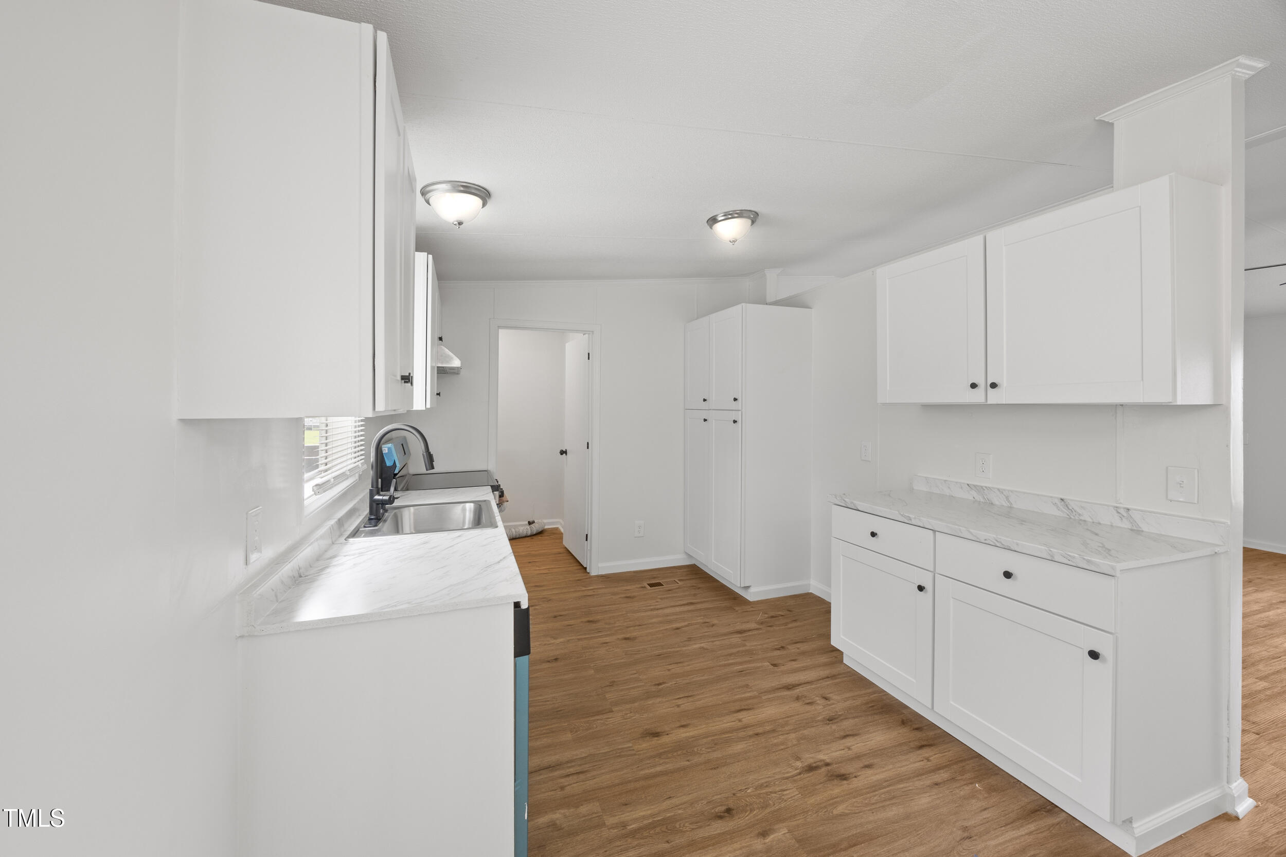 6423 Sandy Creek Road Stedman, NC 28391 - Photo 24 of 40 a kitchen with sink stove and cabinets