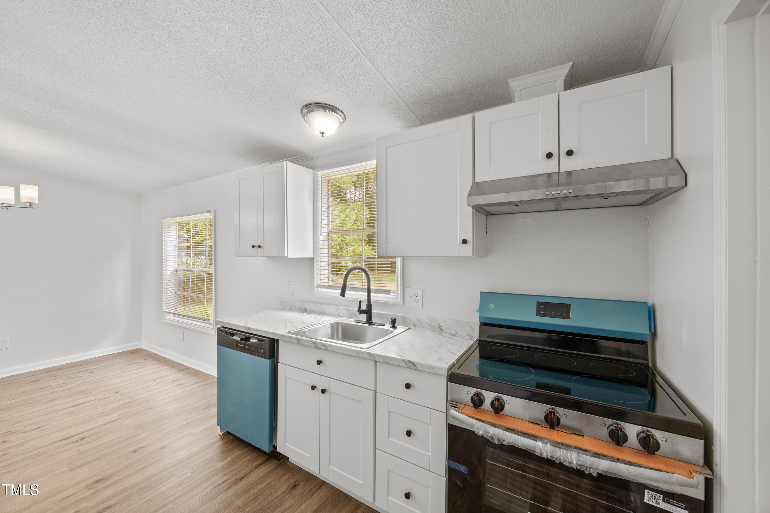 6423 Sandy Creek Road Stedman, NC 28391 - Photo 25 of 40 a kitchen with appliances a sink and cabinets