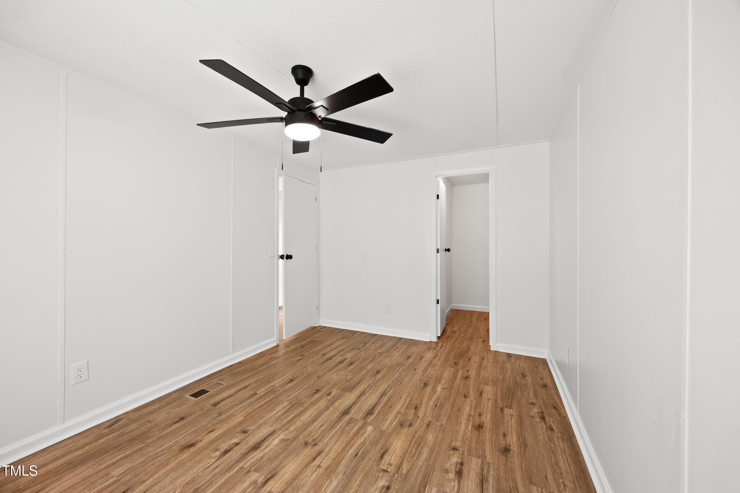 6423 Sandy Creek Road Stedman, NC 28391 - Photo 27 of 40 a view of empty room with wooden floor