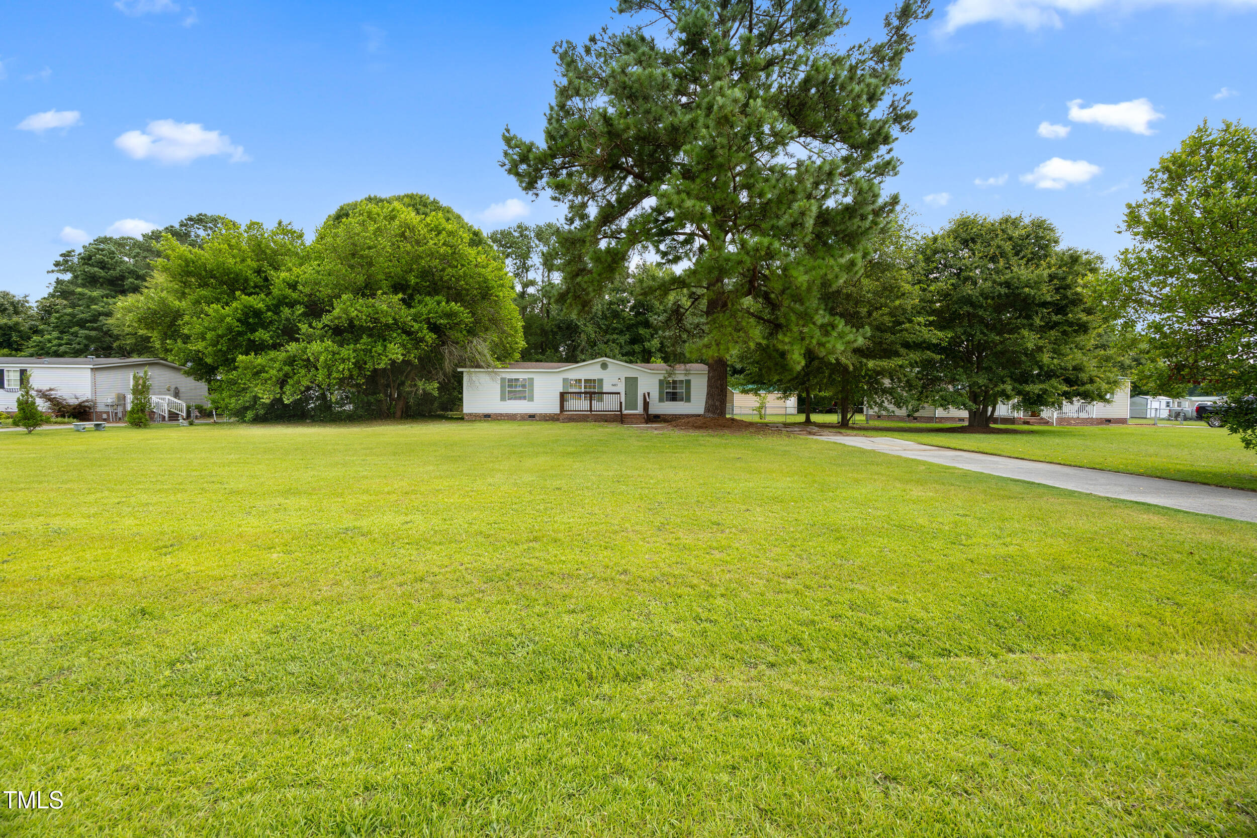 6423 Sandy Creek Road Stedman, NC 28391 - Photo 5 of 40 a view of a swimming pool with an outdoor space and seating area