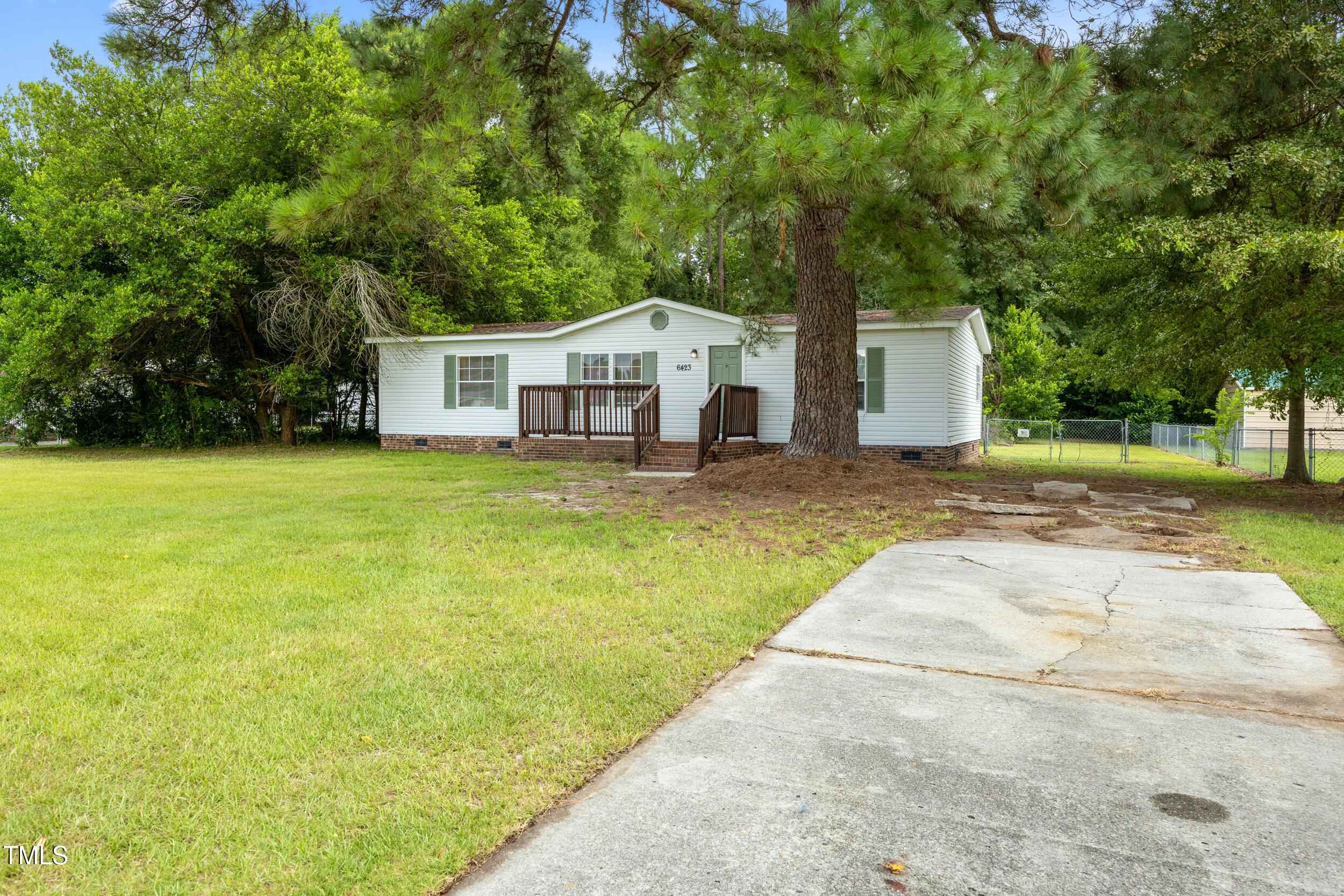 6423 Sandy Creek Road Stedman, NC 28391 - Photo 8 of 40 a house view with a sitting space and garden