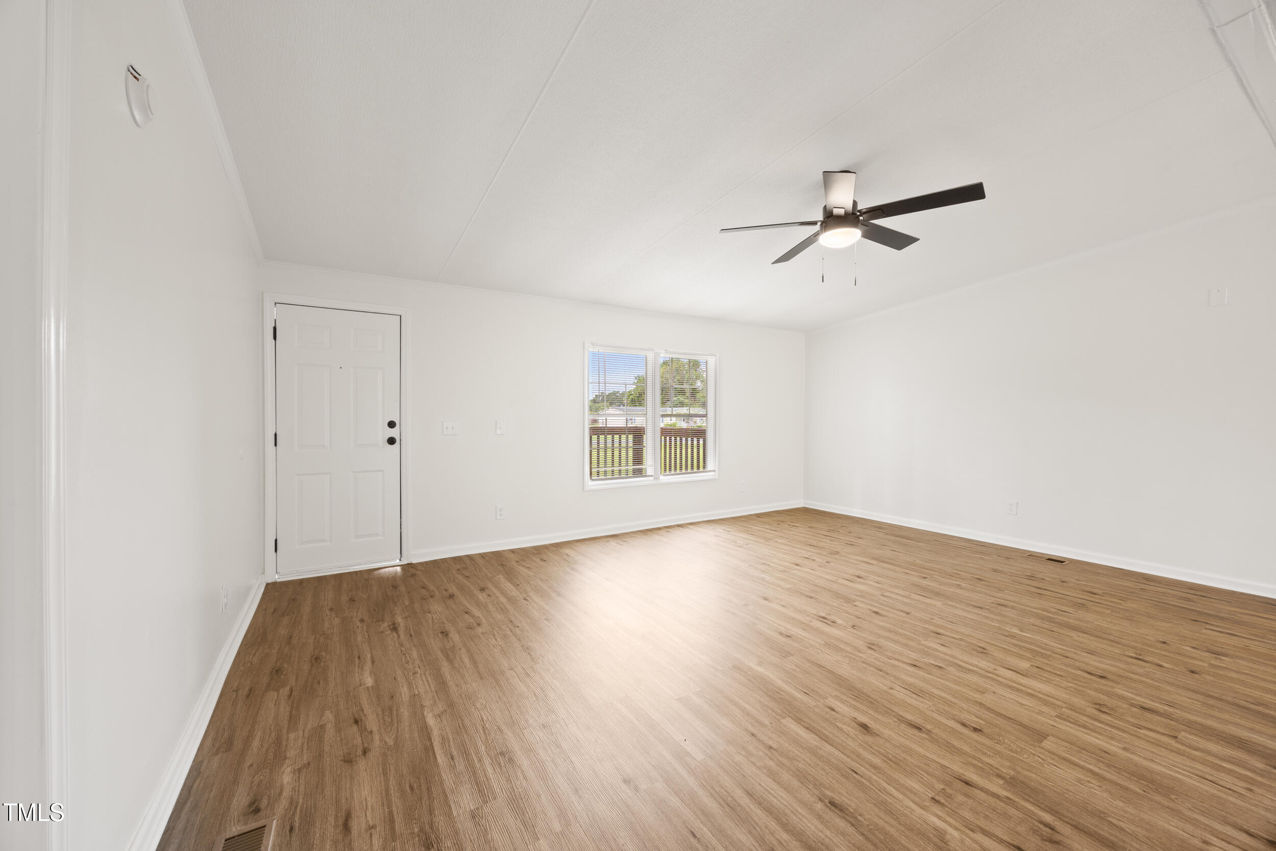 6423 Sandy Creek Road Stedman, NC 28391 - Photo 9 of 40 a view of empty room with wooden floor and fan