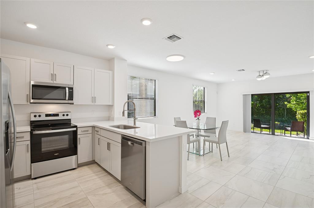 180 Southeast 5th Court Deerfield Beach, FL 33441 - Photo 1 of 25 a kitchen that has a cabinets counter space and appliances