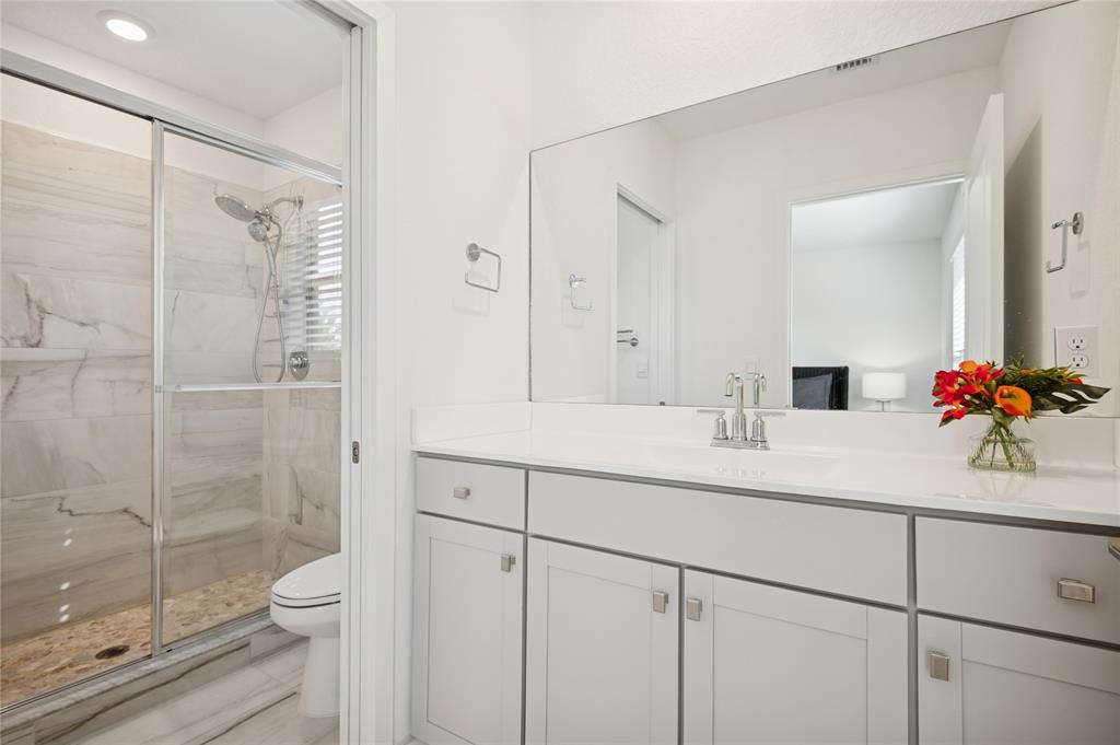 180 Southeast 5th Court Deerfield Beach, FL 33441 - Photo 11 of 25 a bathroom with a double vanity sink toilet and shower