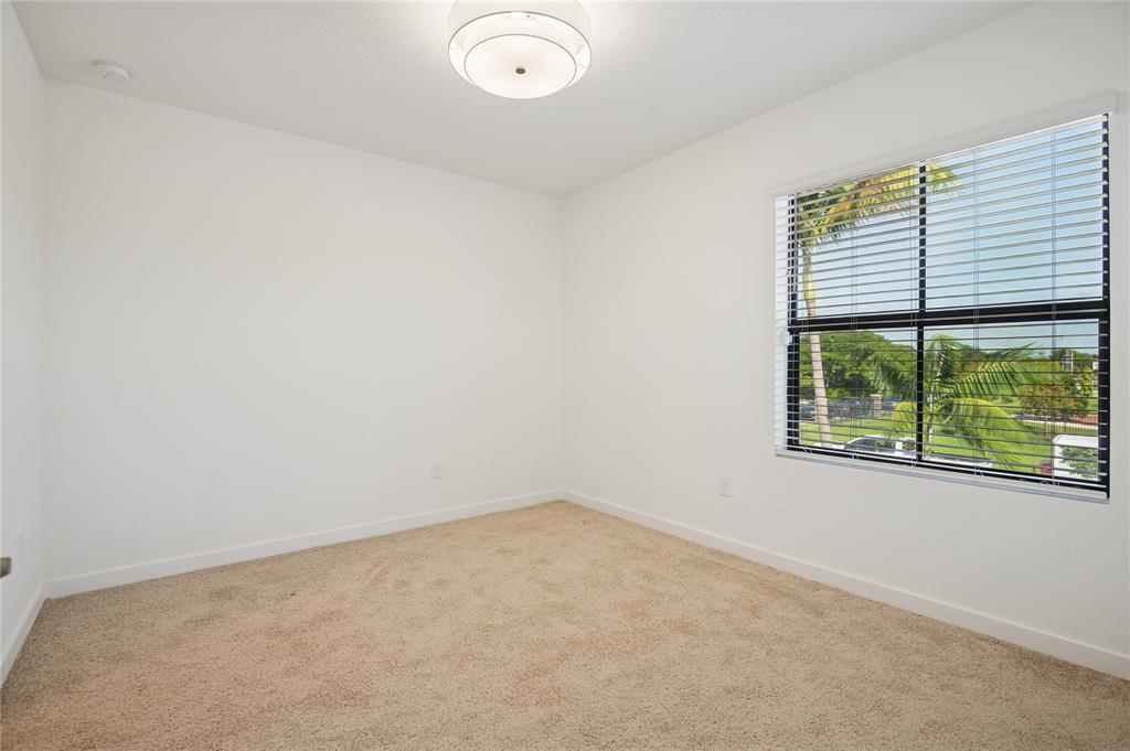 180 Southeast 5th Court Deerfield Beach, FL 33441 - Photo 12 of 25 an empty room with a window