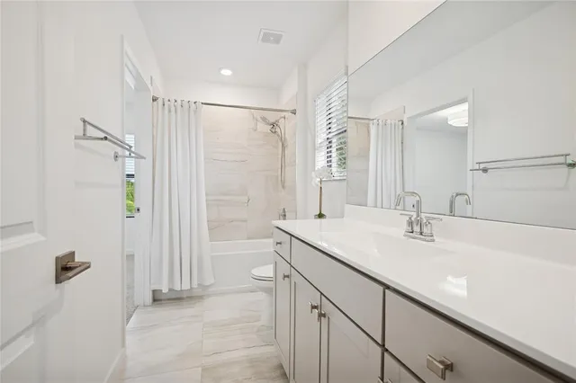 a bathroom with a sink double vanity and shower