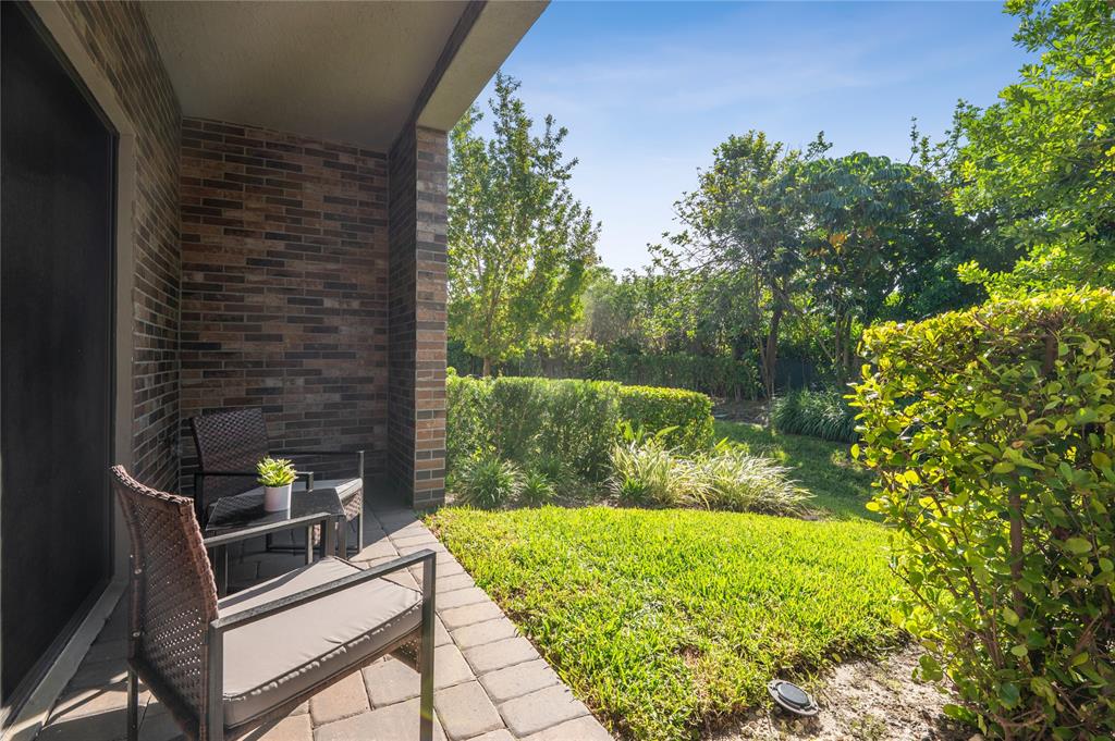 180 Southeast 5th Court Deerfield Beach, FL 33441 - Photo 3 of 25 a view of a garden with a chair