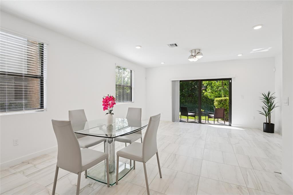 180 Southeast 5th Court Deerfield Beach, FL 33441 - Photo 4 of 25 a dining room with furniture and window