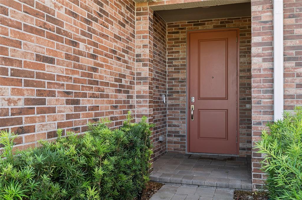 180 Southeast 5th Court Deerfield Beach, FL 33441 - Photo 5 of 25 a couple of potted plants in front of door
