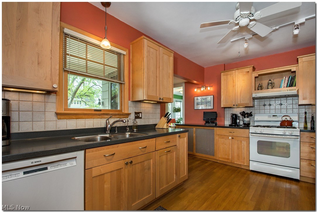 3034 East Overlook Road Cleveland, OH 44118 - Photo 13 of 35 The updated kitchen features wood cabinetry, tiled backsplash, solid surface counters, all appliances included.