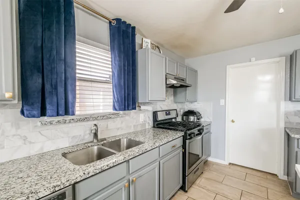 a kitchen with a sink and cabinets