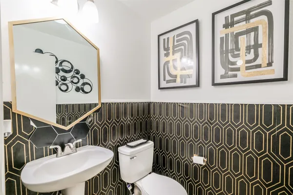 a bathroom with a toilet a sink and mirror