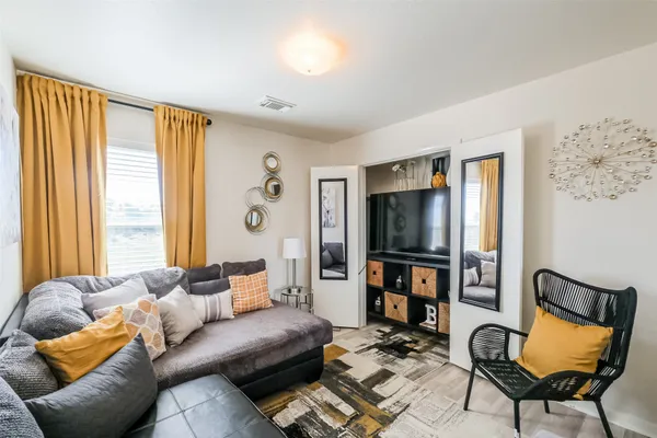 a living room with furniture and a flat screen tv