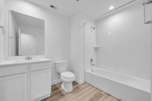 a view of a kitchen and wooden floor