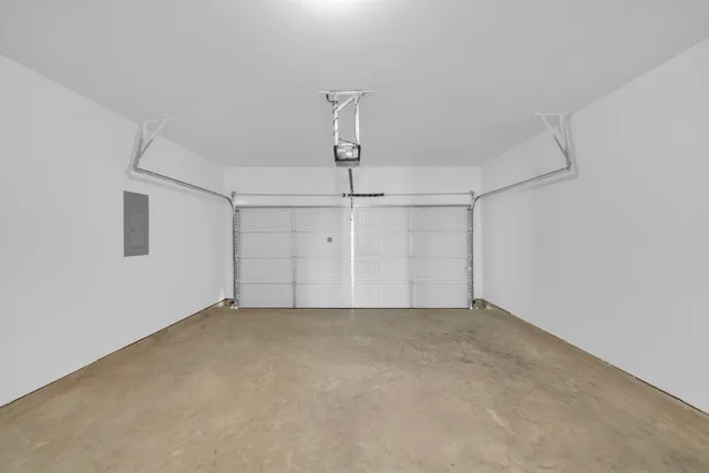 a view of a house with a yard and garage