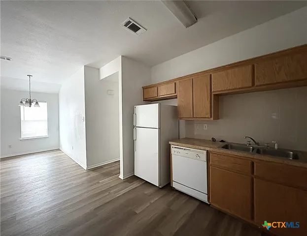 a kitchen with stainless steel appliances a refrigerator and a sink