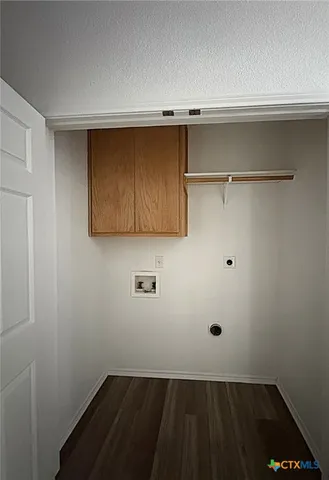 a view of storage and utility room with wooden floor