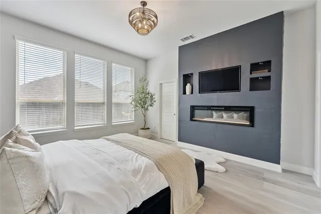 a bedroom with a bed and a tv