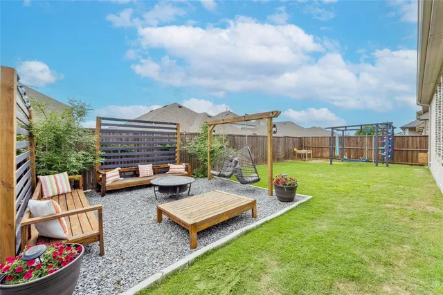 a view of a yard with furniture and a garden