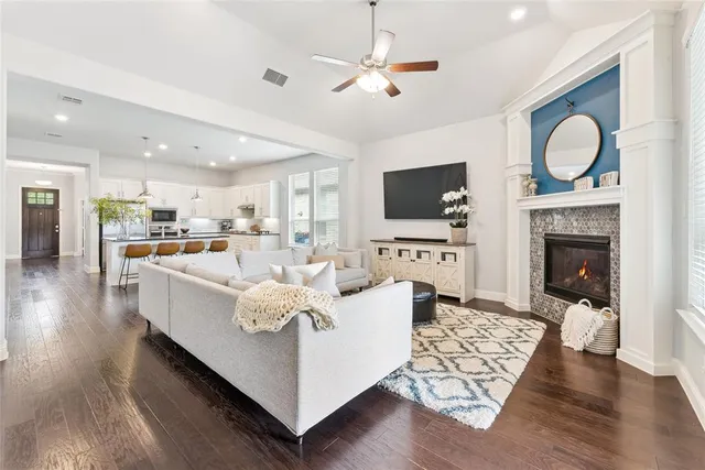 a living room with furniture a fireplace and a television